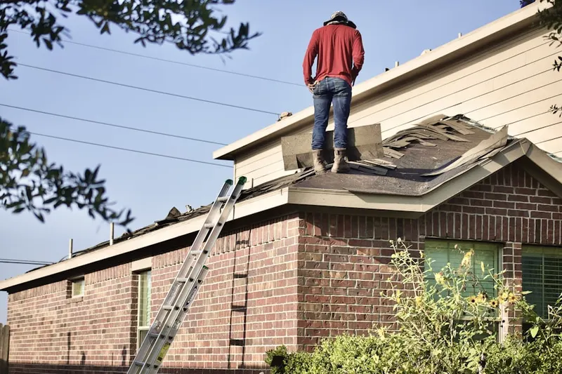 Professional roofer working on a residential roof in Ridge